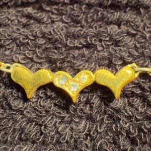 Artistry necklace with three hearts and rhinestones.